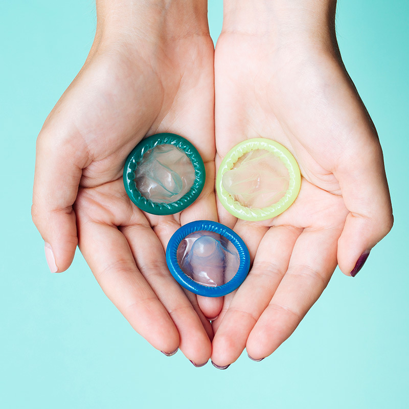 hand holding condoms